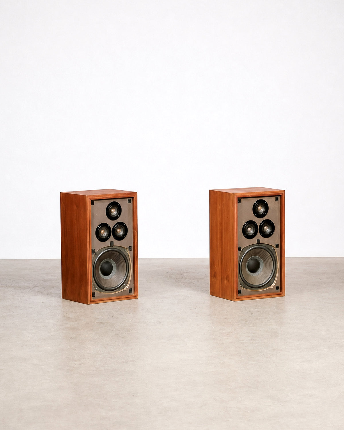 Side angle of the walnut speaker cabinet showing the wood grain and joinery.