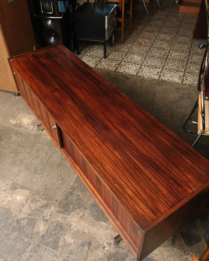 Overhead view of the rosewood credenza top, highlighting the bookmatched grain and clean edges