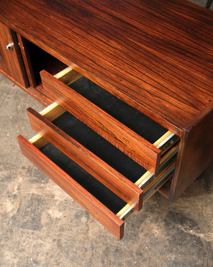 Interior view of the credenza with three drawers open, revealing rosewood fronts and metal slides