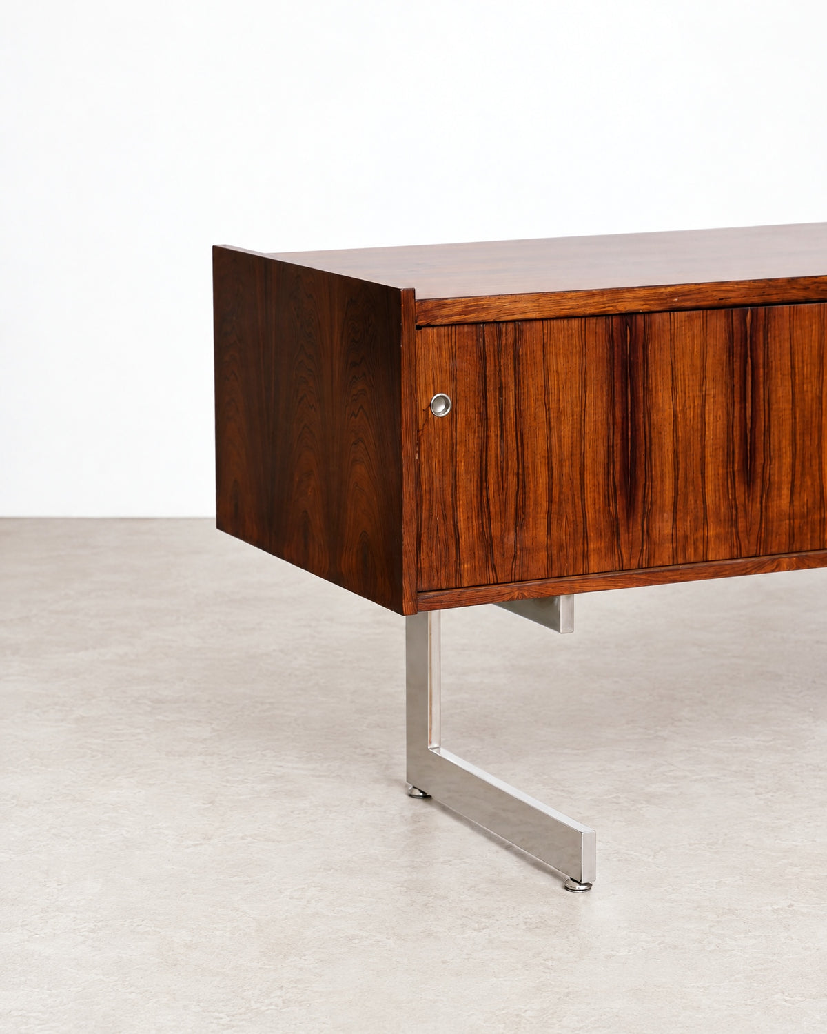 Close-up of the rosewood credenza's door pull and surface finish