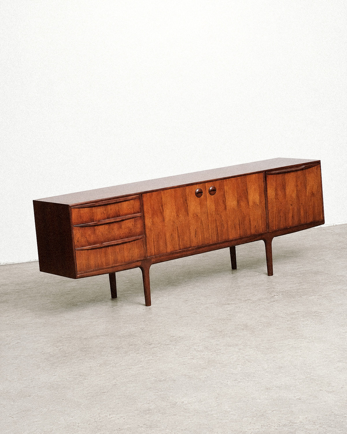 Close-up of a tapered leg and the join to the cabinet base.