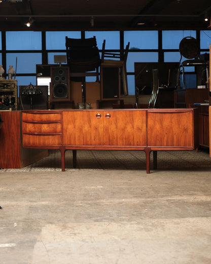 Front view of the rosewood Dunfermline sideboard showing drawers, two-door cabinet, and tapered legs.