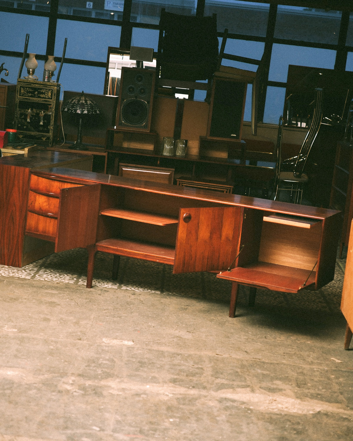 Side angle showing the drop-front compartment open with drawers and cabinet doors also open.