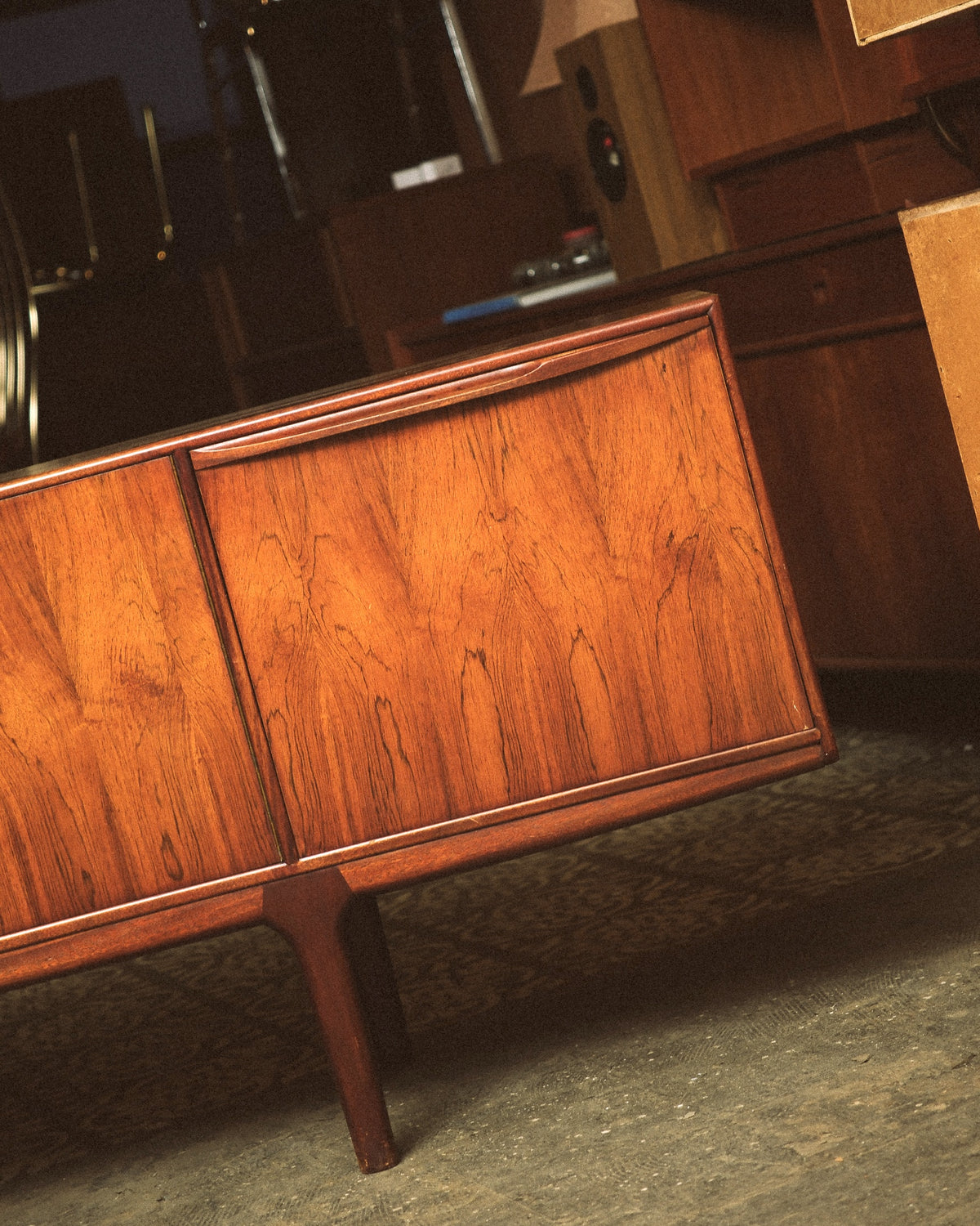 Additional front angle of the sideboard showing the full length and tapered leg design.