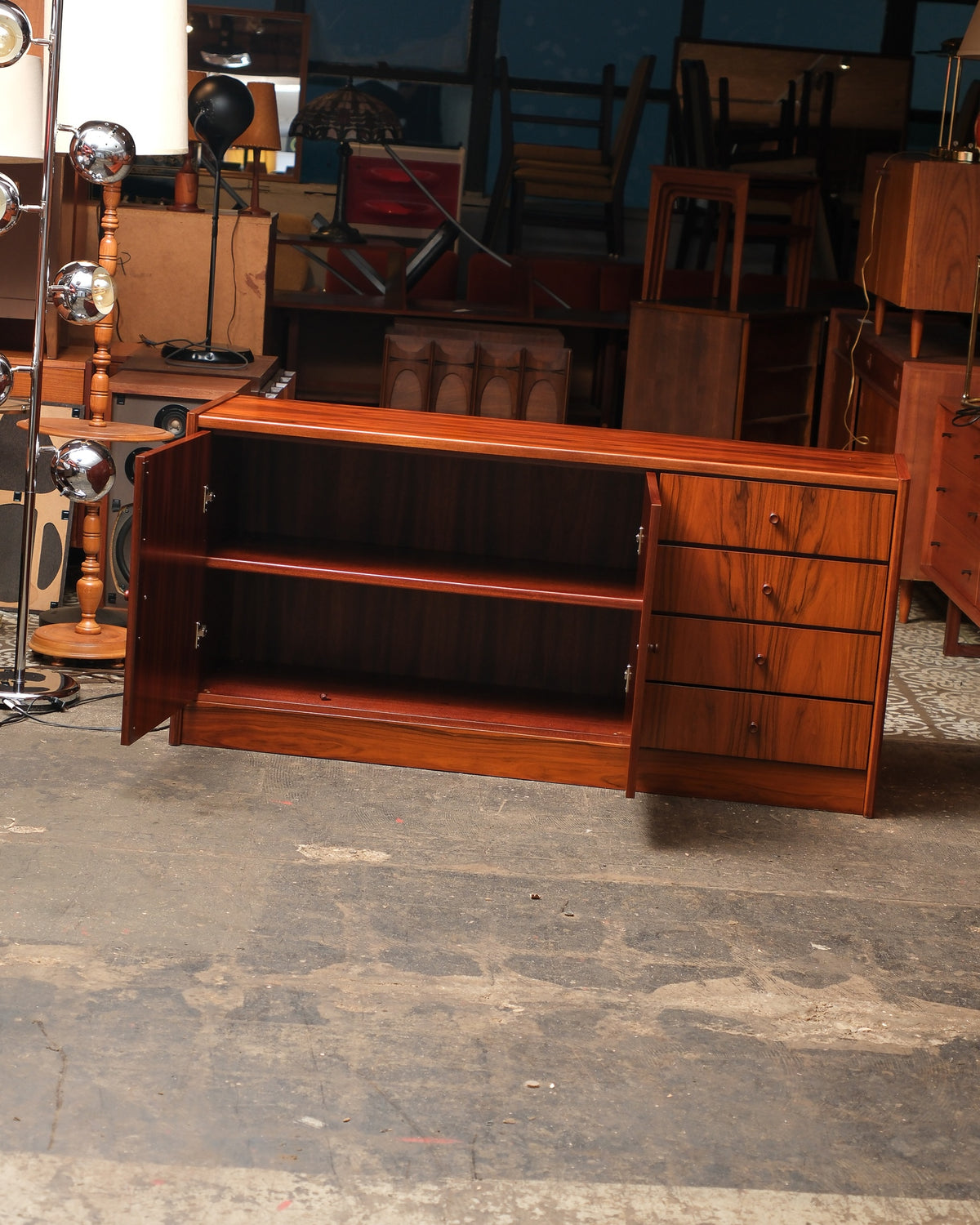 Full view of the sideboard with left cabinet doors open, revealing two adjustable interior shelves.