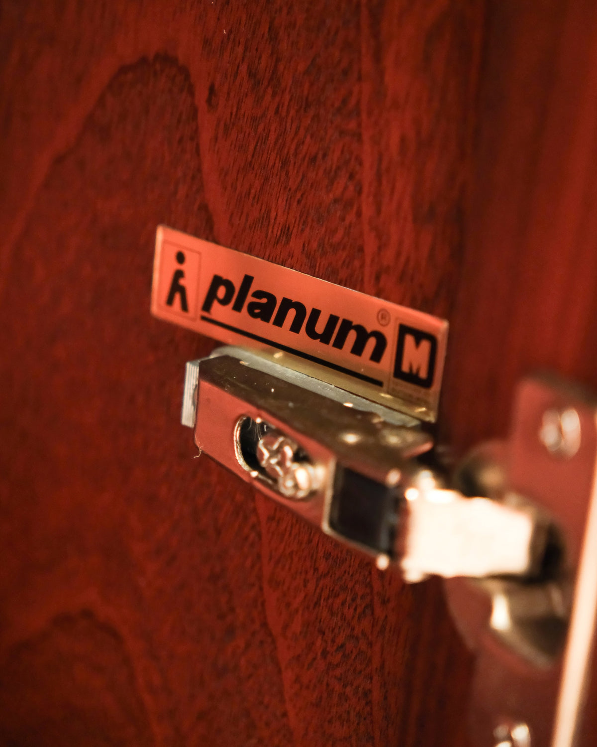 Close-up of the Planum maker's tag mounted on the interior door hinge.
