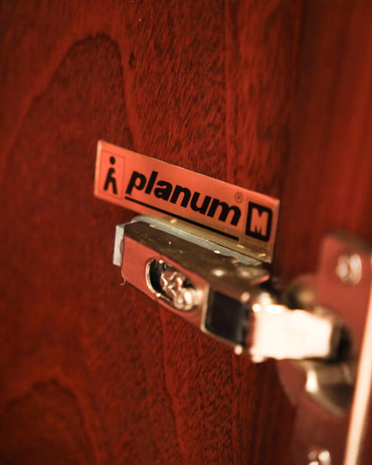 Close-up of the Planum maker's tag mounted on the interior door hinge.