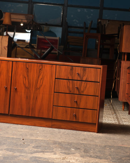 Front view of the closed sideboard showing two cabinet doors and four drawers with round pulls.