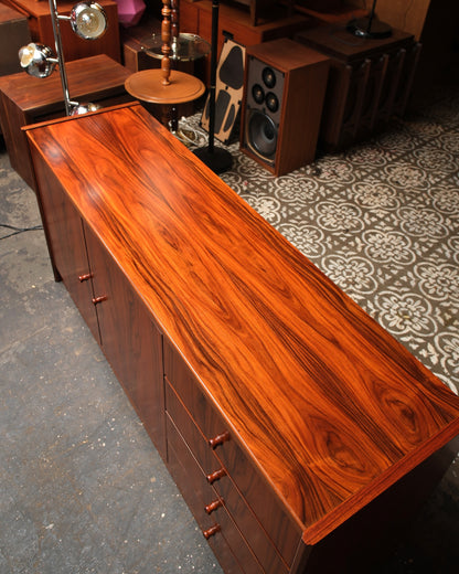 Elevated angle showing the sideboard's top surface grain and drawer pulls along the front.