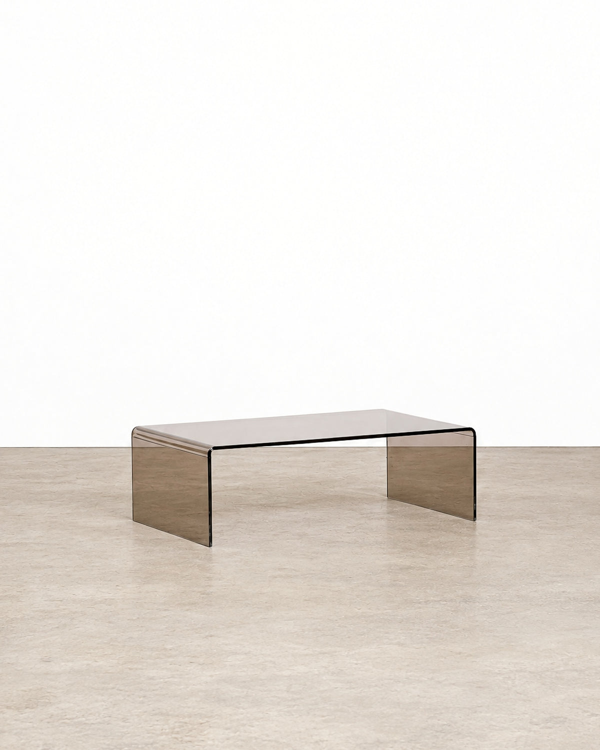 Additional angle of the smoked lucite waterfall coffee table showing its overall form and proportions.