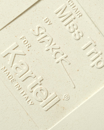 Close-up of embossed maker's mark reading Miss Trip chair by Philippe Starck for Kartell, Made in Italy.