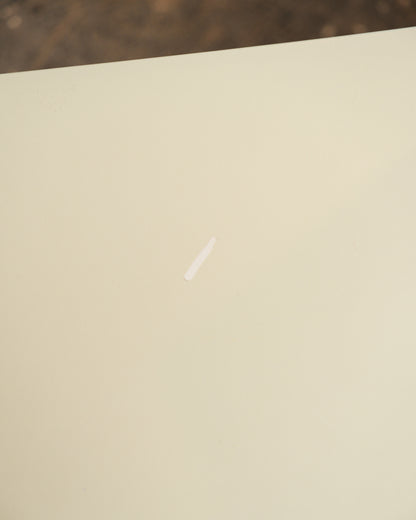 Close-up of the cream seat surface showing a small visible scratch.
