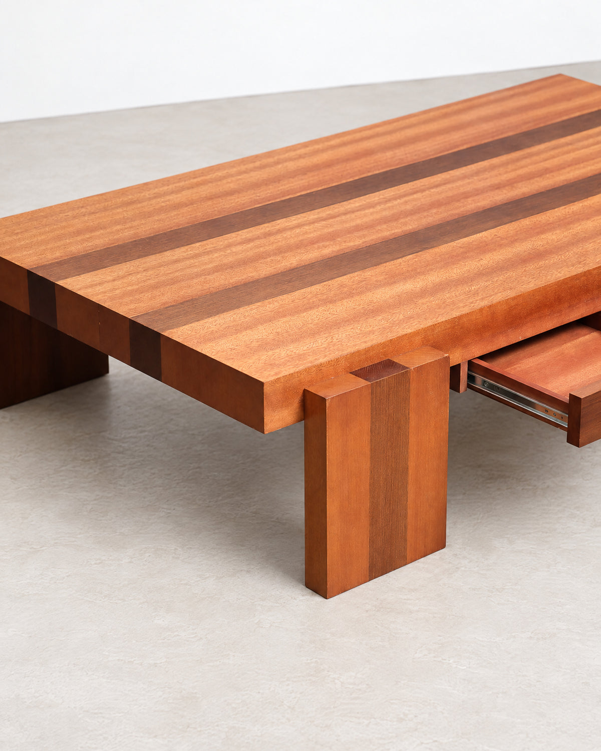 Detail of the block leg and drawer front showing wood grain and joinery.