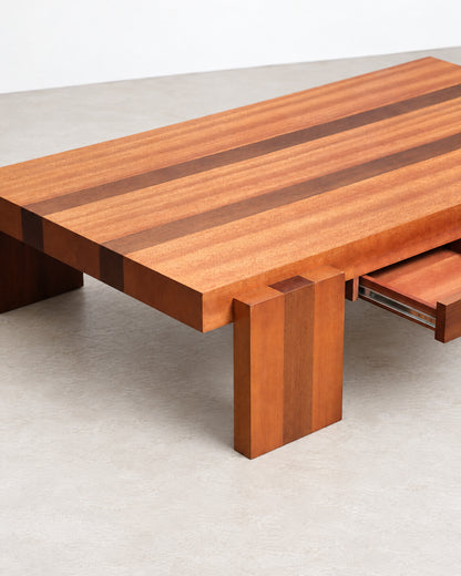 Detail of the block leg and drawer front showing wood grain and joinery.