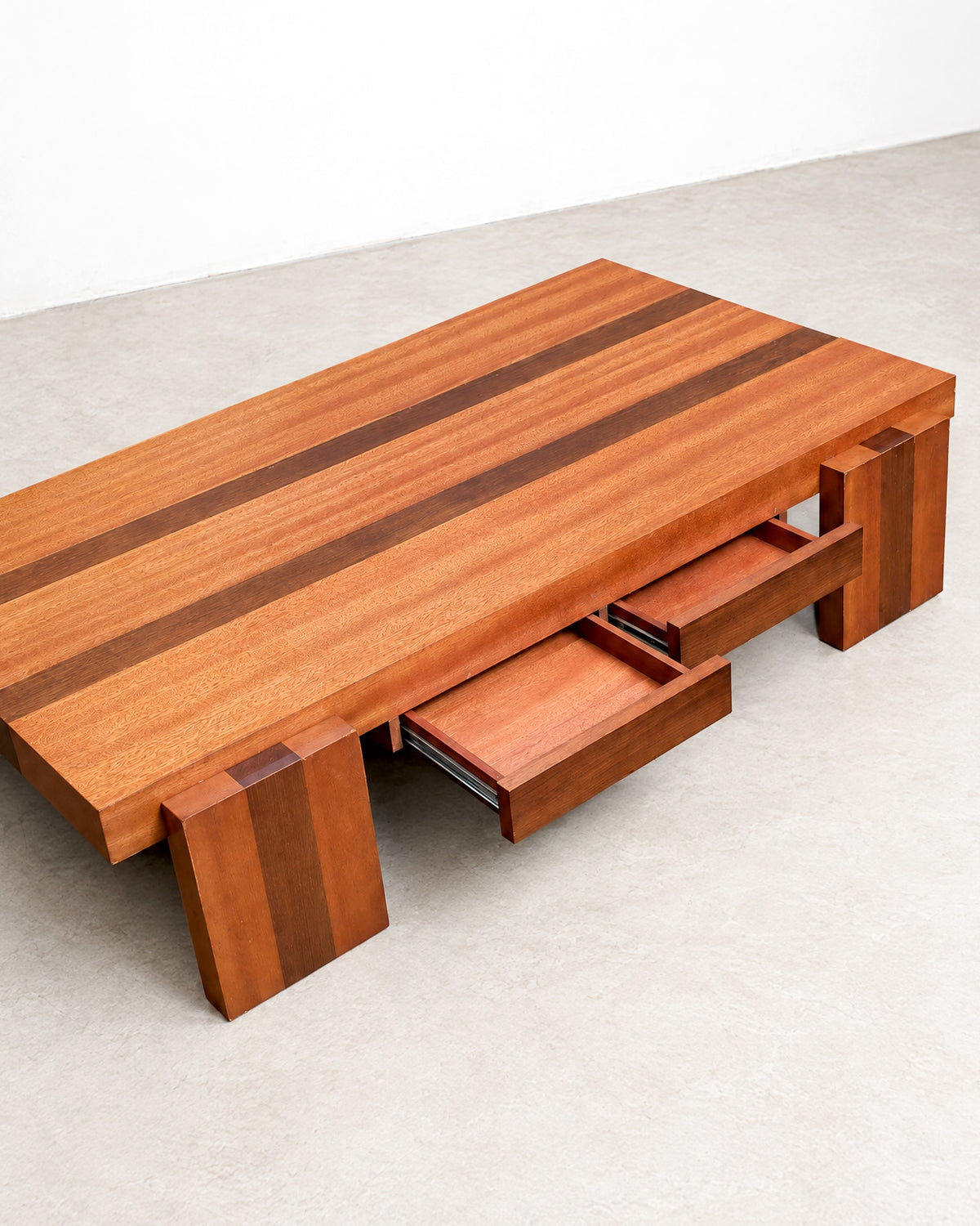 Overhead angled view of the coffee table with both drawers open, showing metal slides.