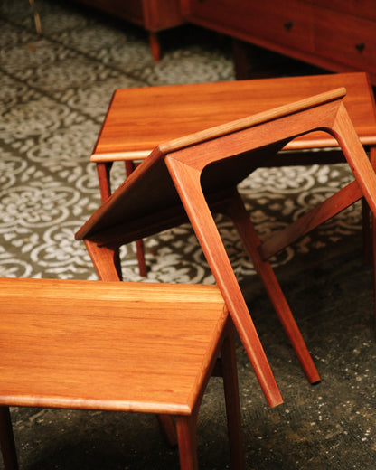 Side view of the nesting tables highlighting the curved leg design