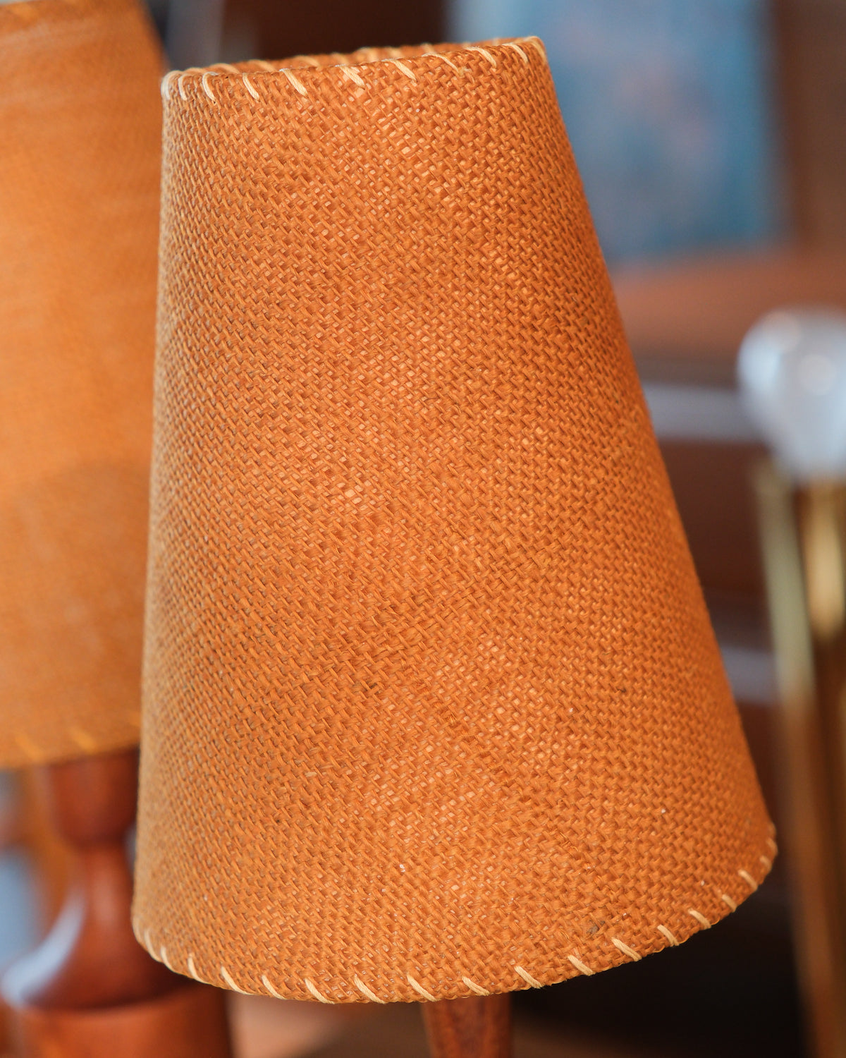 Close-up of the woven shade's texture and whipstitched edge on the vintage table lamp.