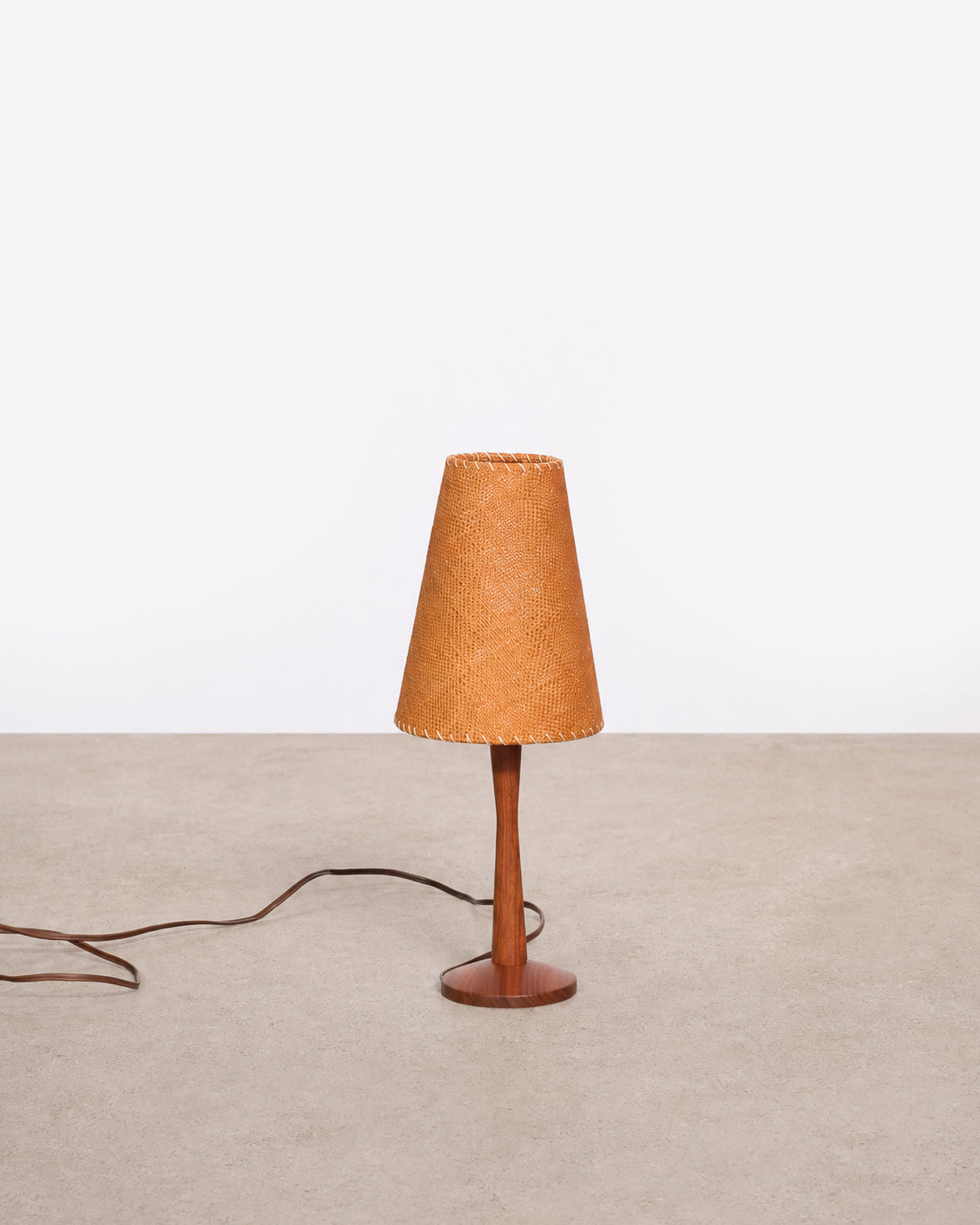 Full view of the vintage teak table lamp with woven shade against a plain white background.