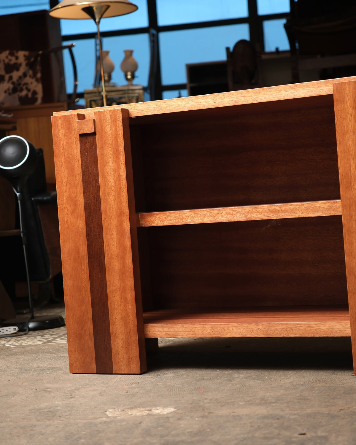 Side view showing the open shelving and striped banding along the cabinet's edge.