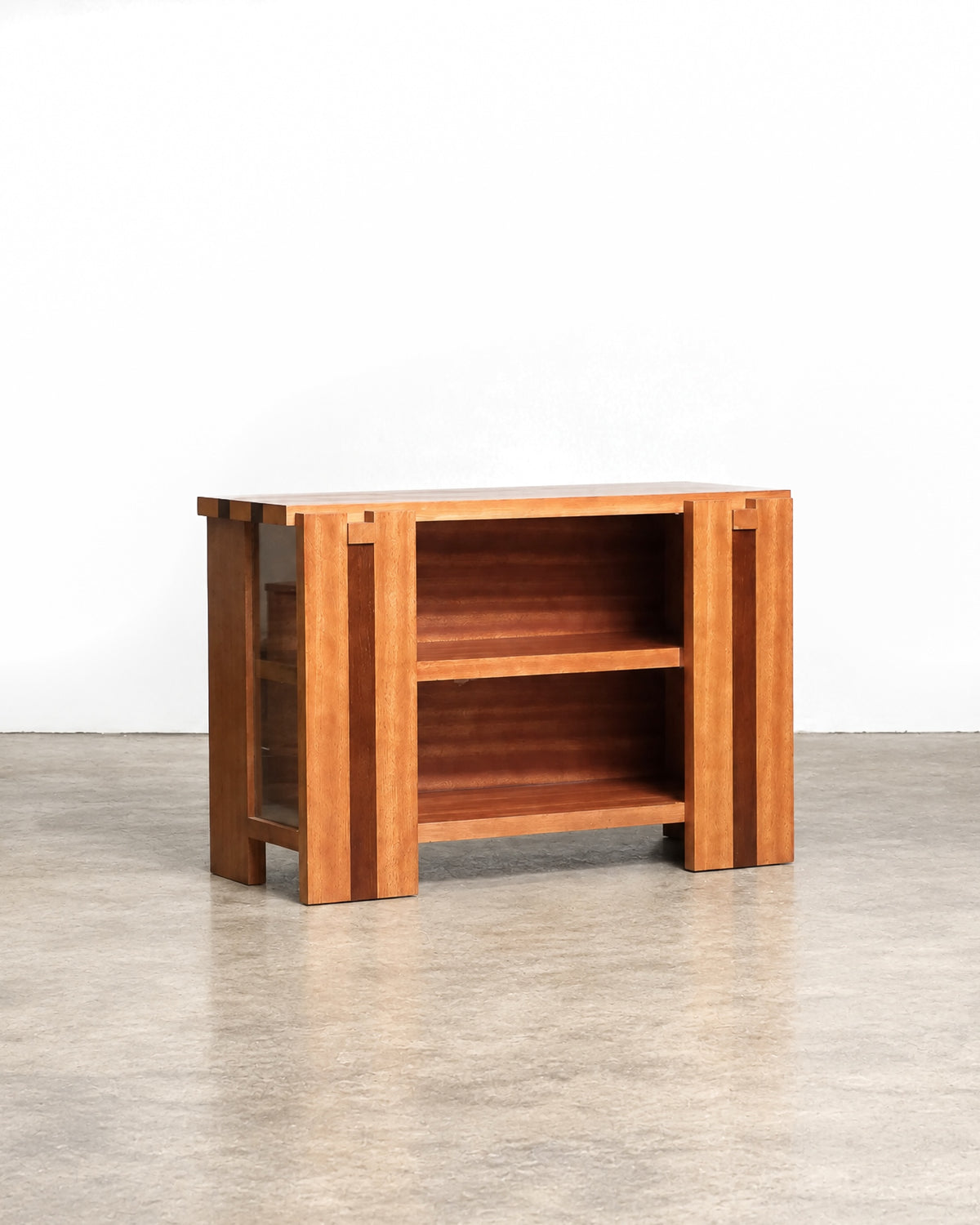 Front view of the two-tone hardwood cabinet with open shelving and glass door.