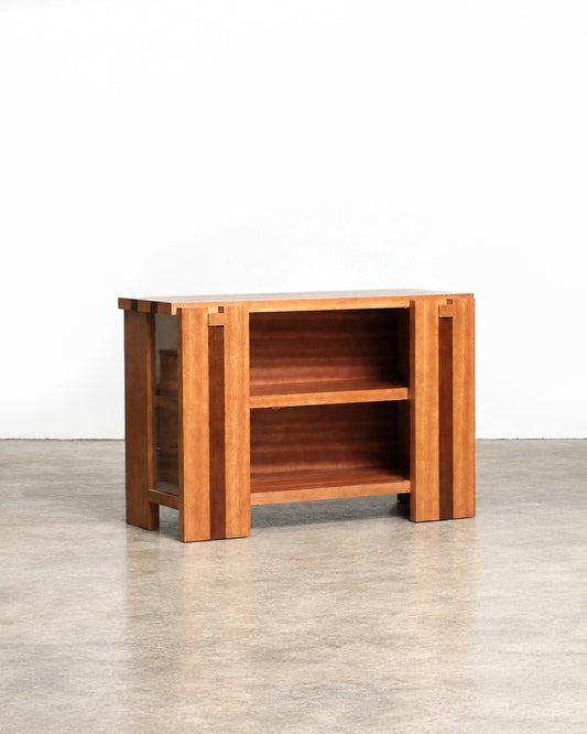 Front view of the two-tone hardwood cabinet with open shelving and glass door.