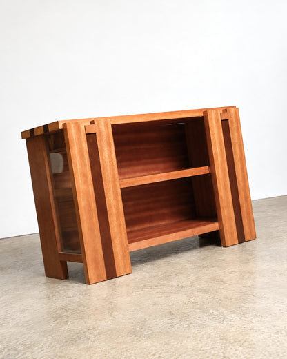 Angled view of the cabinet showing both the glass door side and open shelf side.