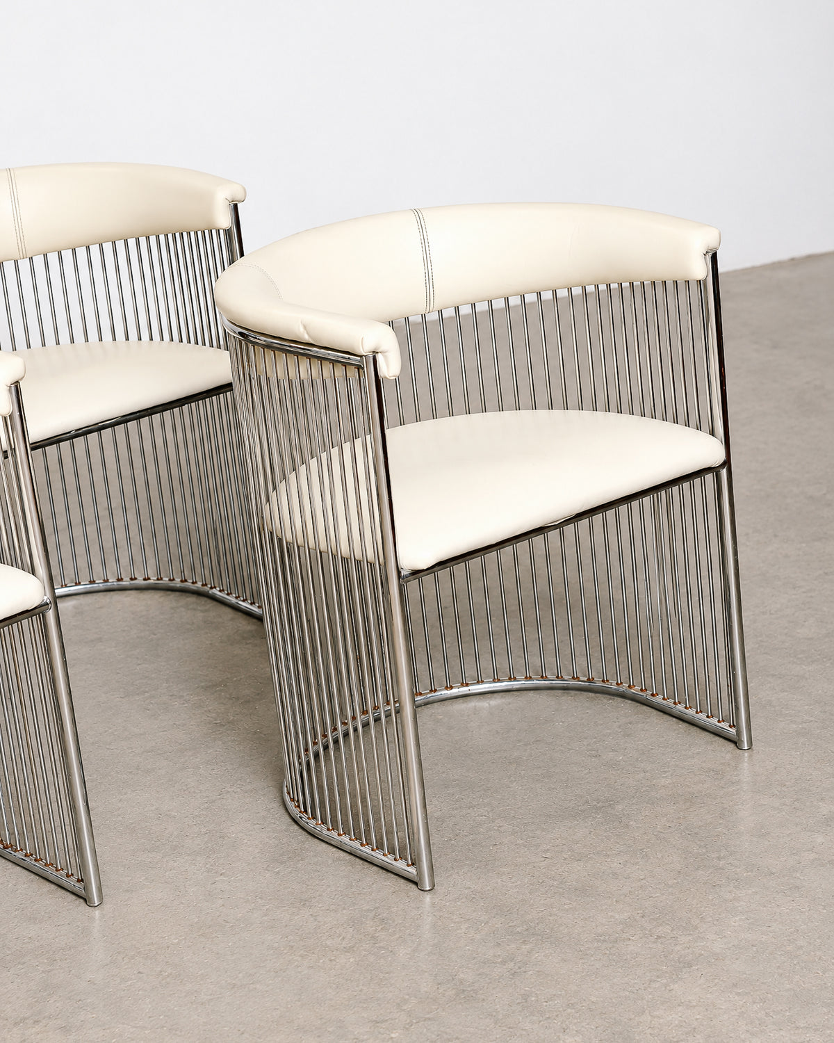 Front view of a single chair showing the barrel shape and leatherette cushion.
