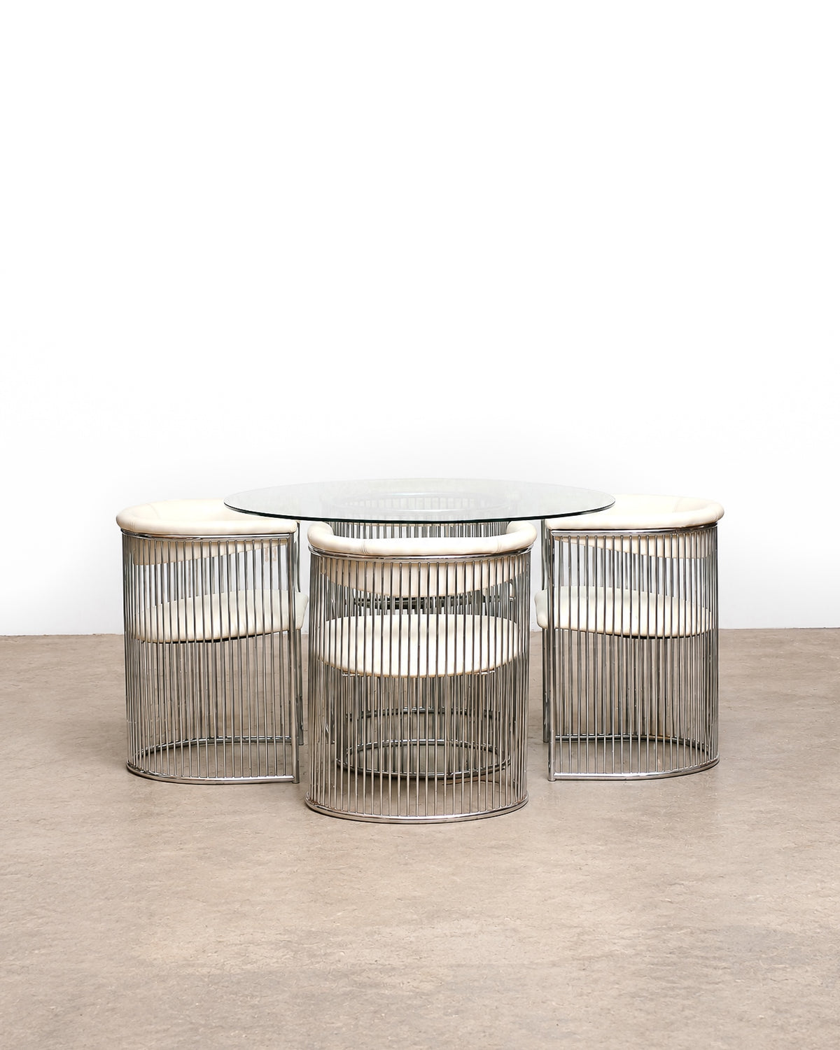 Full set view showing all four chairs and the round table from a slight elevation.