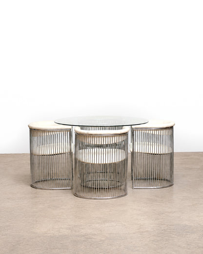 Full set view showing all four chairs and the round table from a slight elevation.