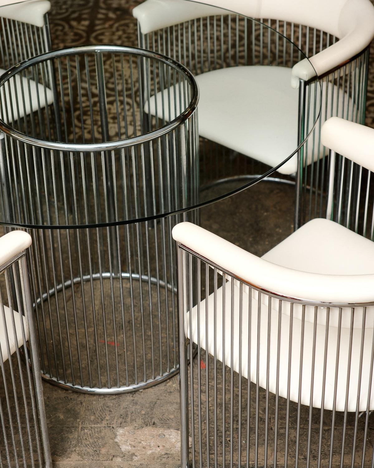 Side view of the chrome rod base table showing its cylindrical form.