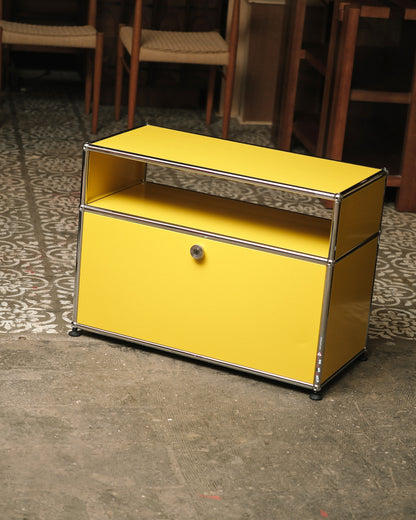 Full view of the USM Haller side table showing open shelf and locking cabinet below.