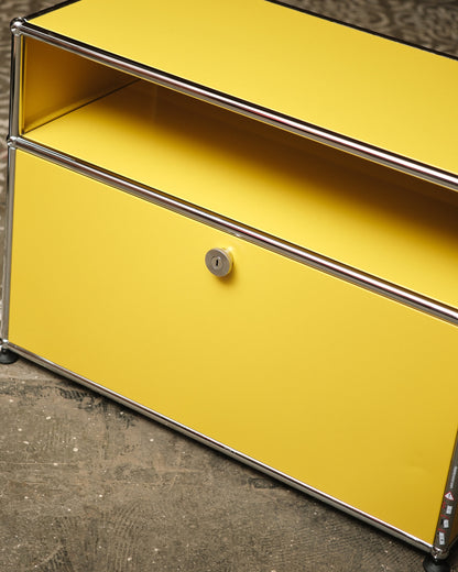 Angled close-up of the open shelf, lock, and chrome frame joinery.