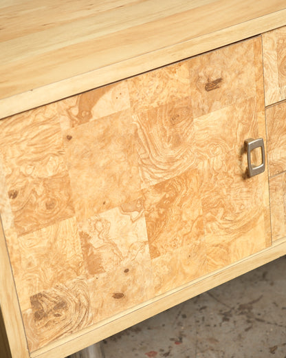 Close-up of the burl veneer door front and metal pull on the vintage burlwood sideboard.