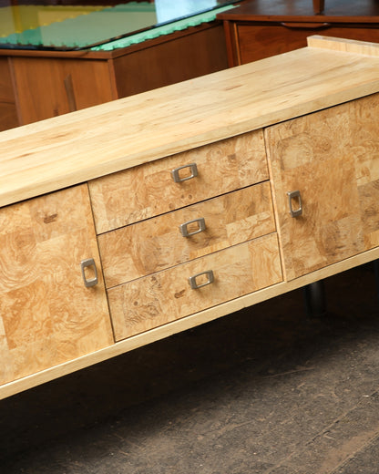 Overhead angle of the sideboard top showing the solid wood surface and burl drawer fronts.