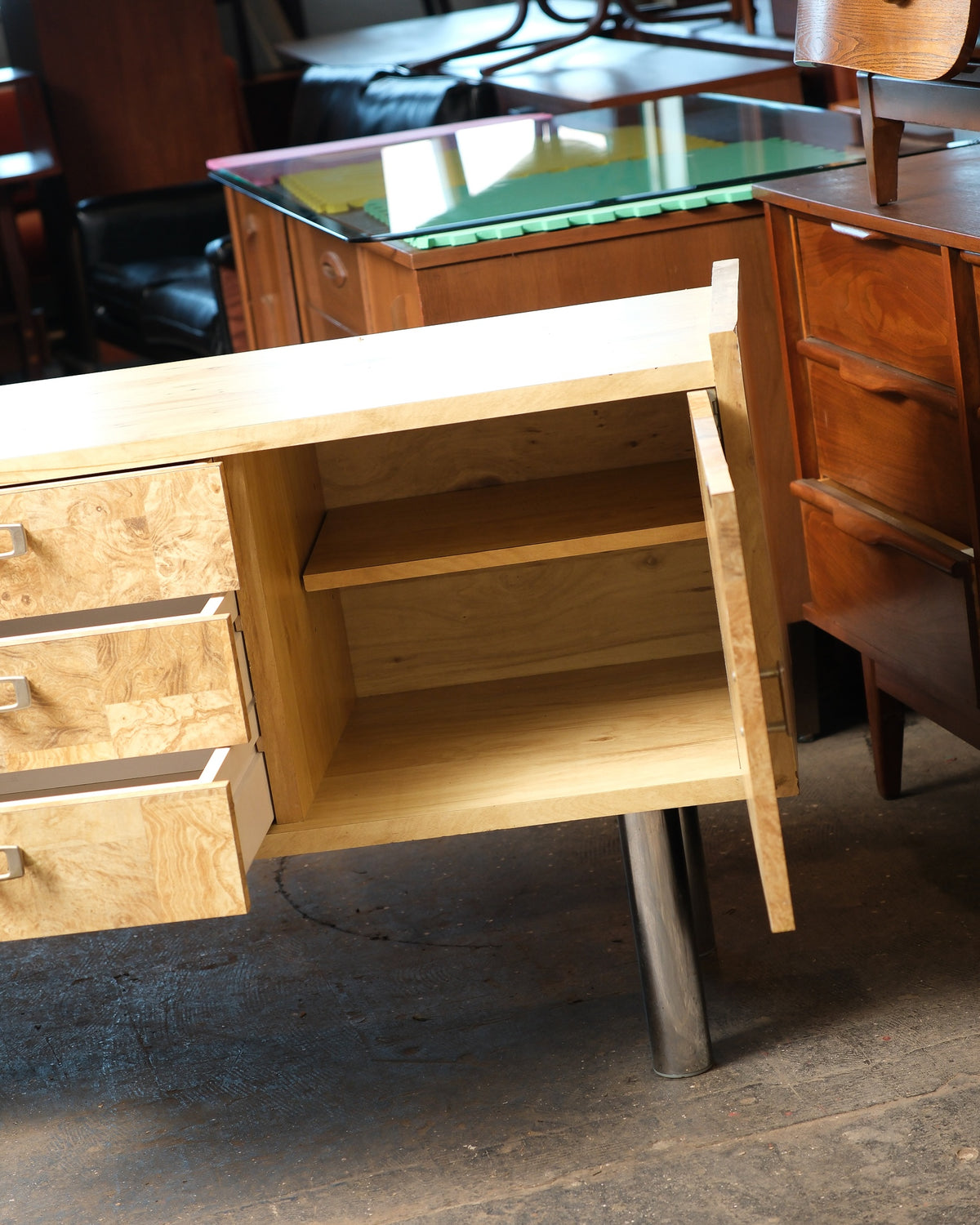 Open cabinet door revealing the adjustable interior shelf.