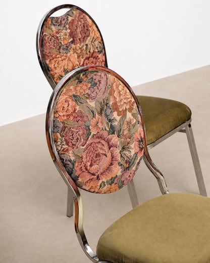 Floral-patterned chair backrest with green cushion on a neutral background