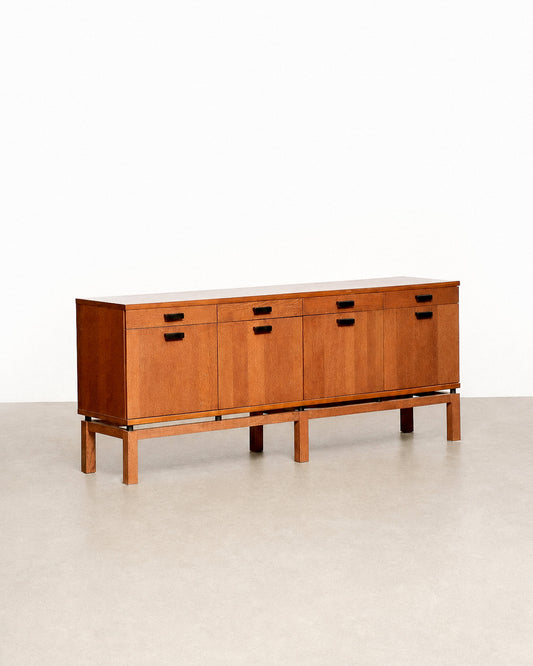 Wide shot of the oak sideboard in the showroom setting alongside other vintage furniture.