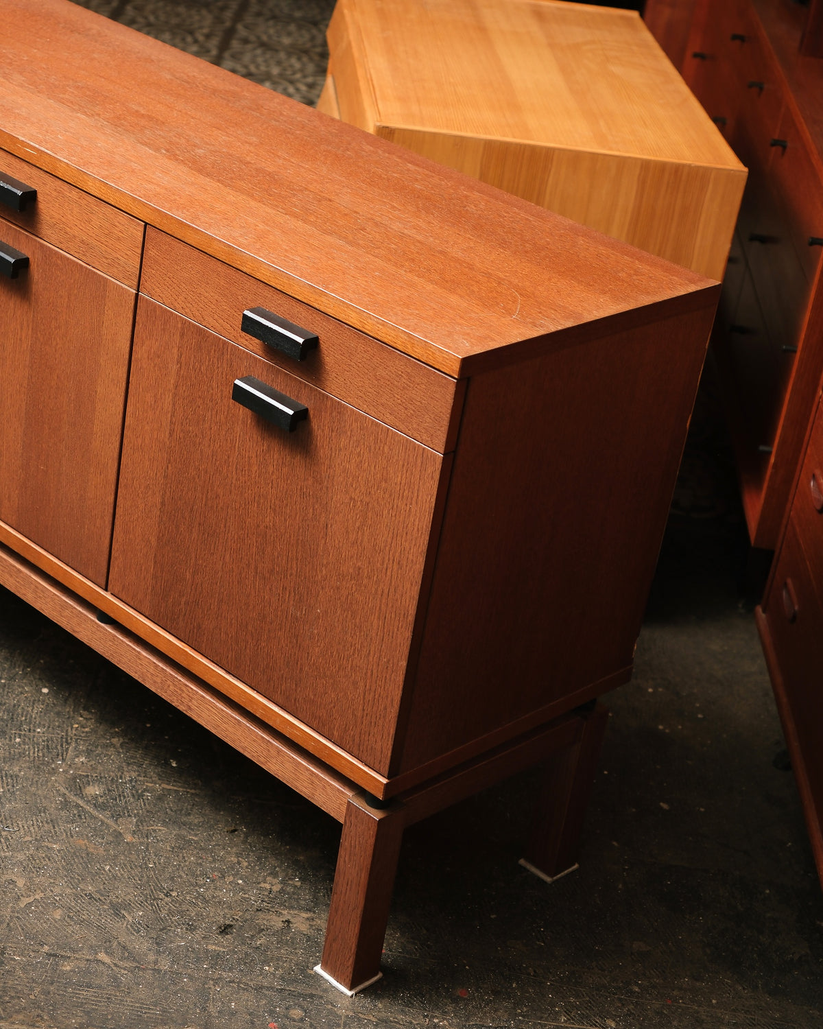 Close-up corner view of the oak sideboard showing drawer and door construction and grain detail.