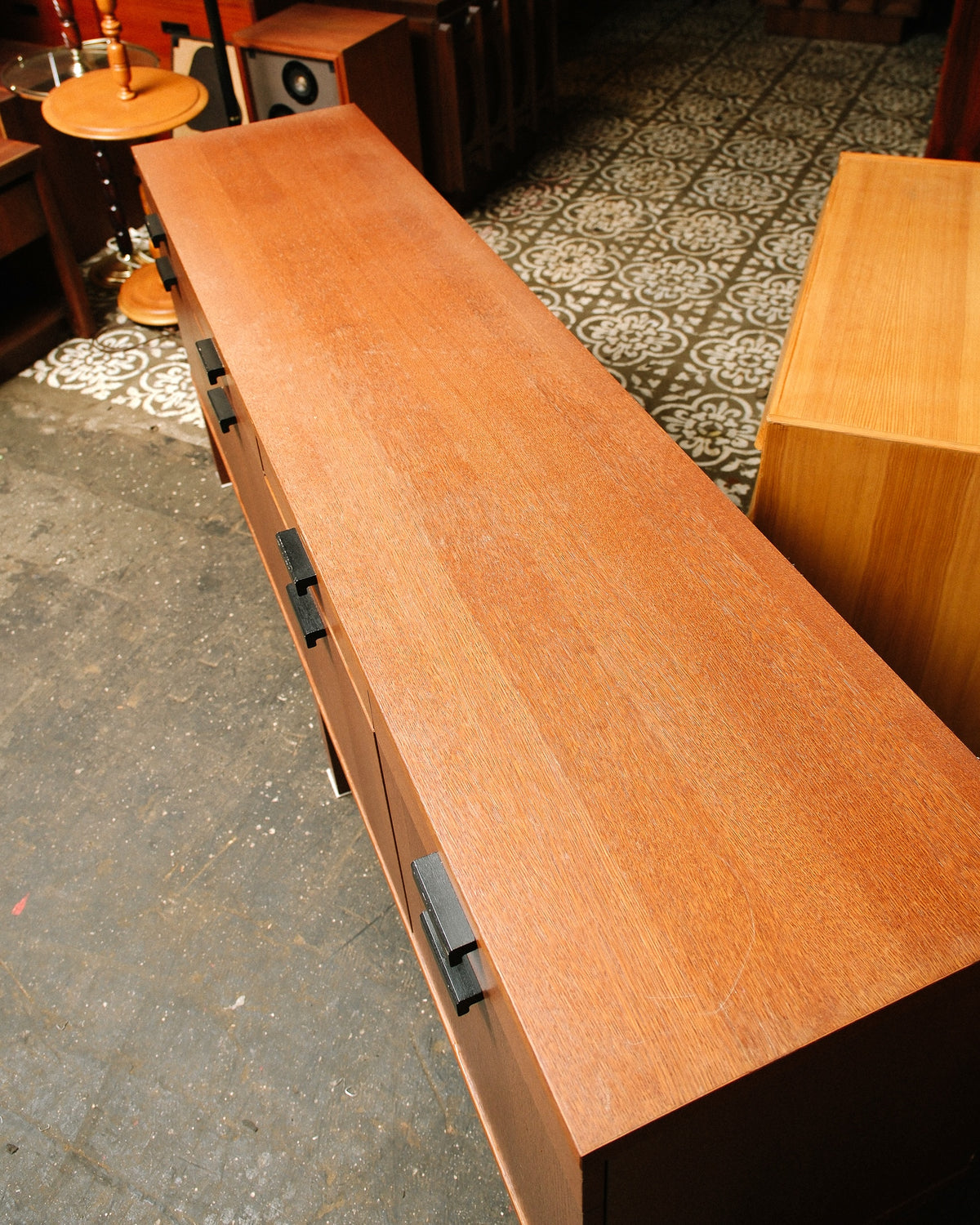 Overhead view of the oak sideboard's top surface showing veneer grain and drawer pulls below.