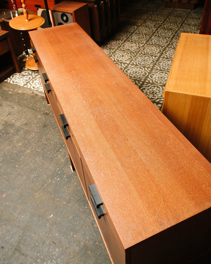 Overhead view of the oak sideboard's top surface showing veneer grain and drawer pulls below.