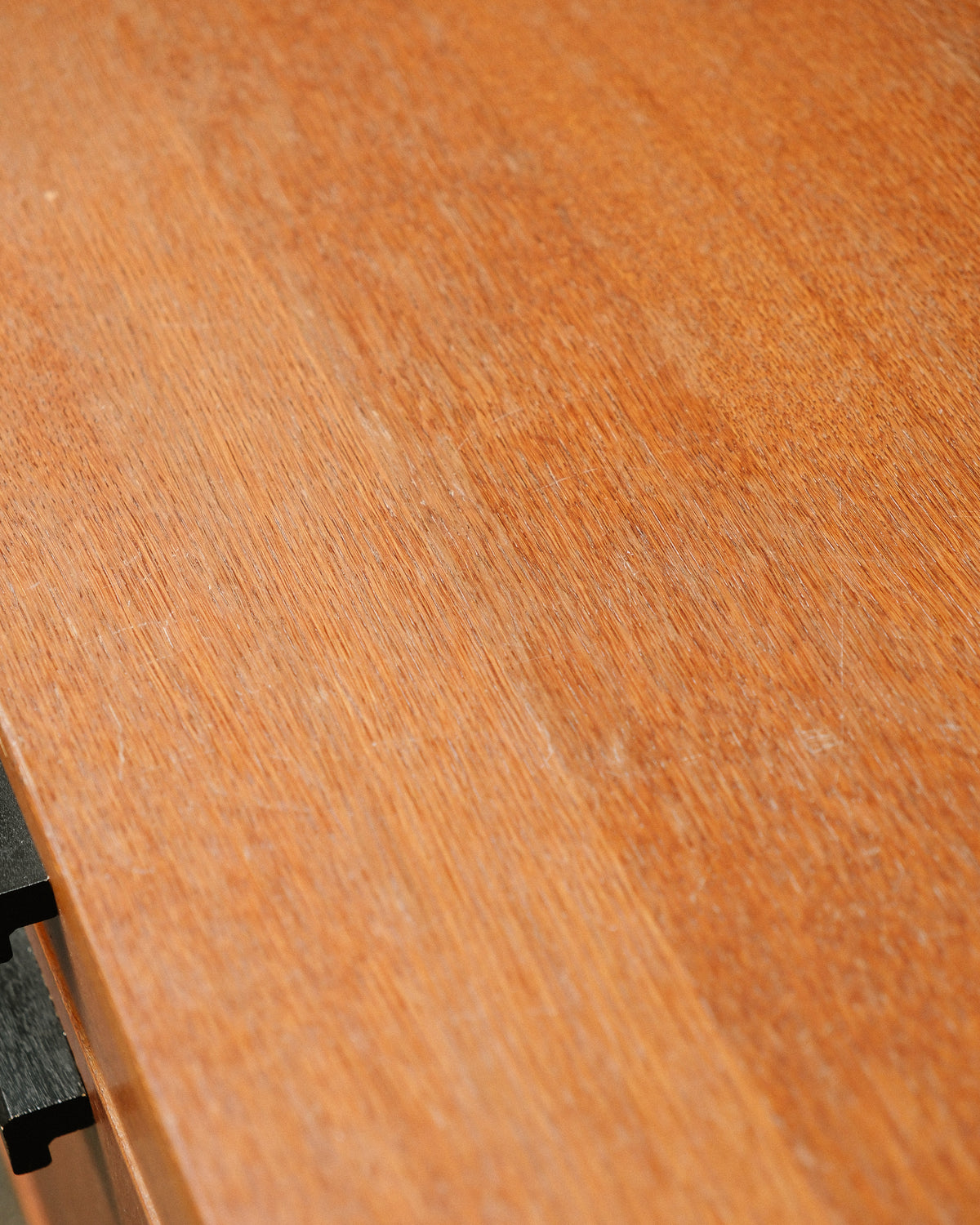 Close-up detail of the oak veneer top surface showing natural grain and light surface wear.