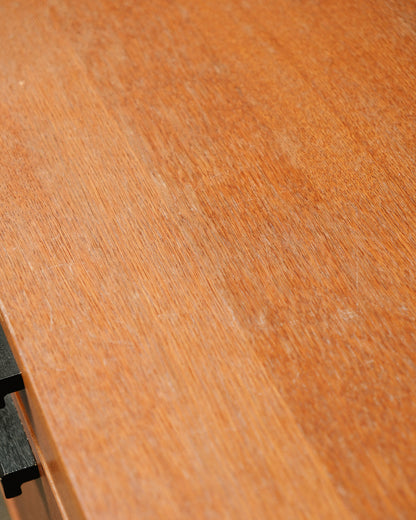 Close-up detail of the oak veneer top surface showing natural grain and light surface wear.