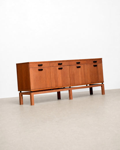 Detail of the black drawer and door pulls against the oak veneer.