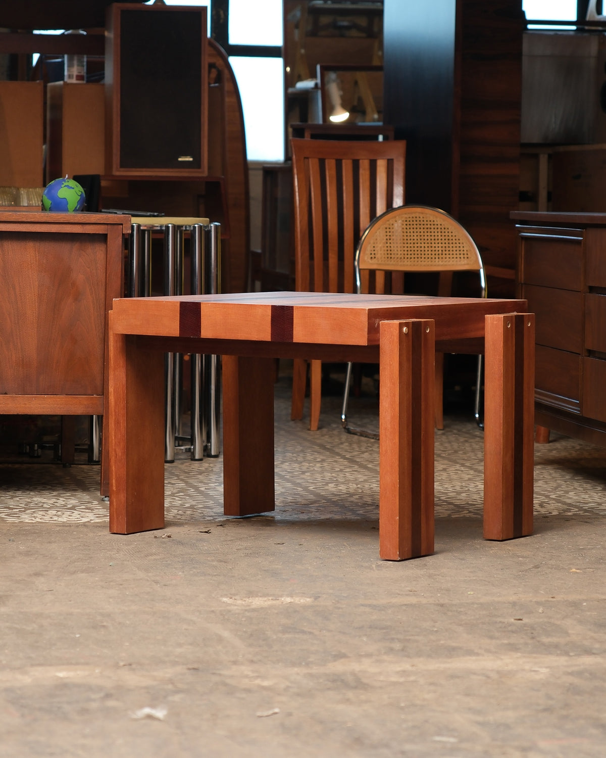 Front view of the coffee table in a showroom with chairs and cabinets in the background.