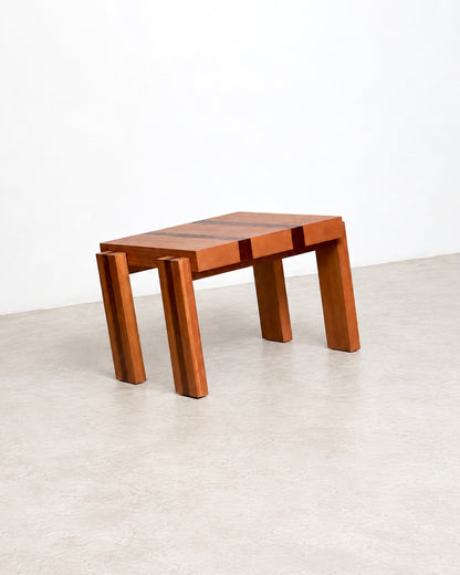 Three-quarter studio view of the coffee table showing its square form and tapered legs.