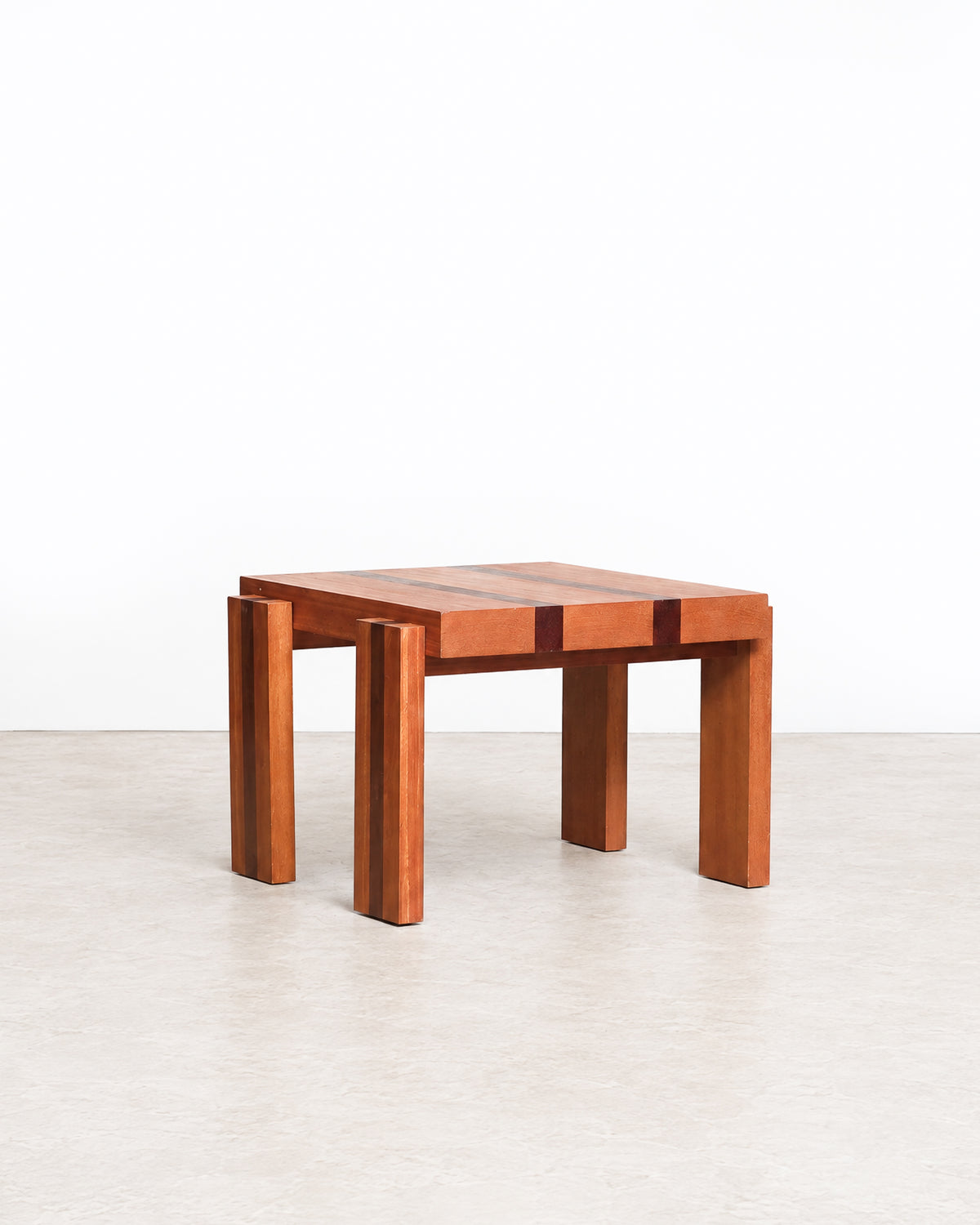 Further studio view of the coffee table highlighting its geometric design and wood tones.