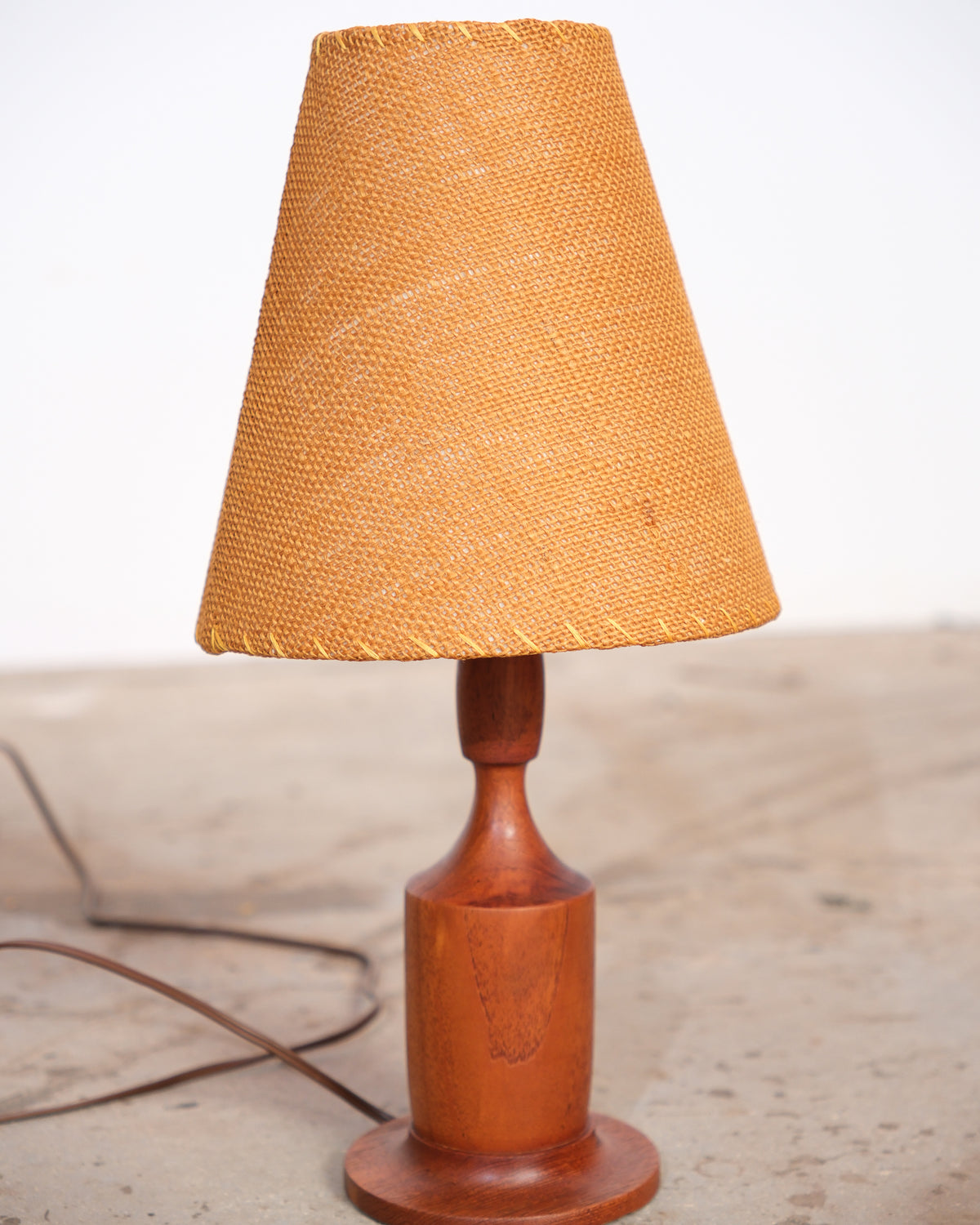 Front view of the walnut lamp showing base and shade proportions.