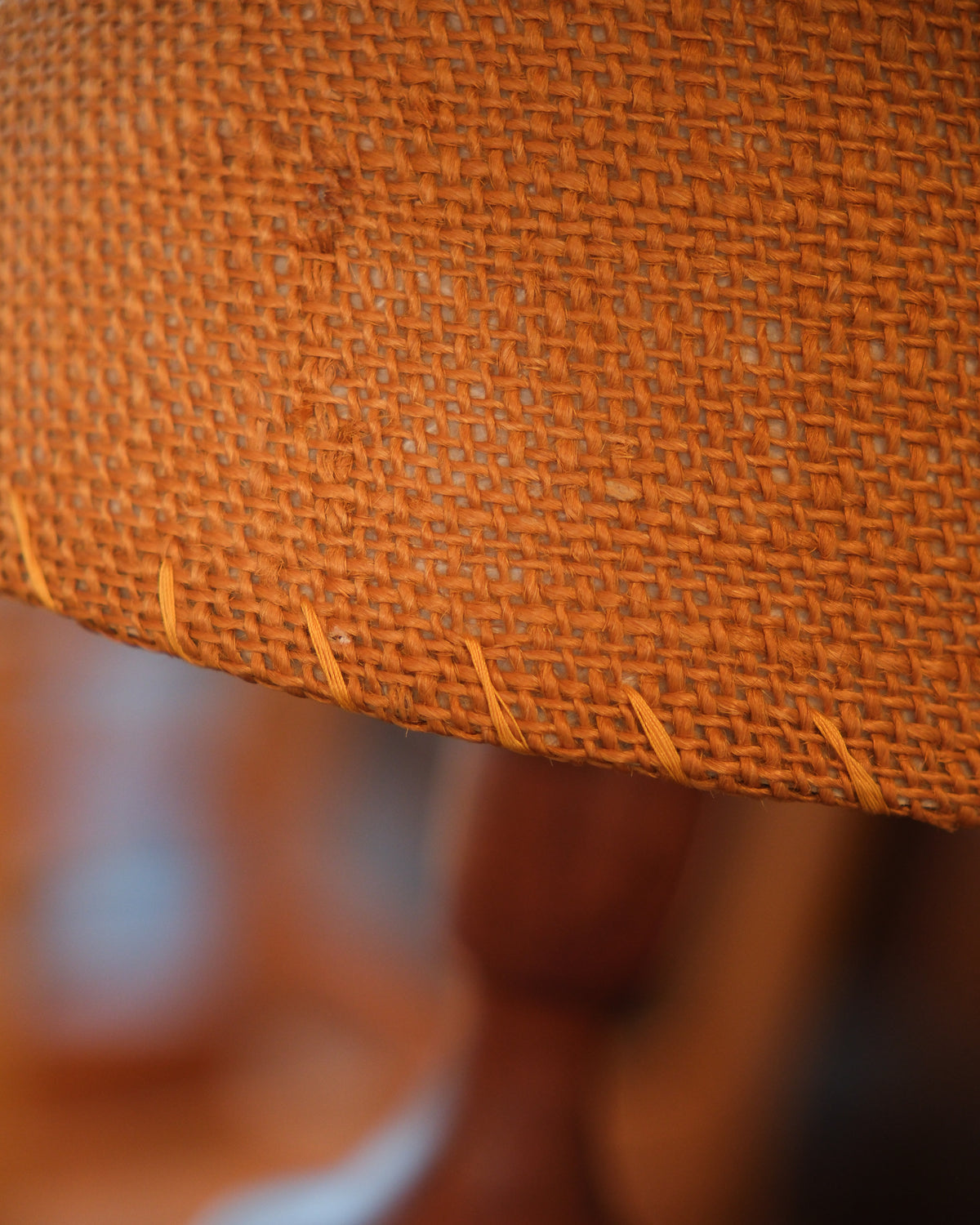 Close-up detail of the wicker shade's stitched edge and texture.