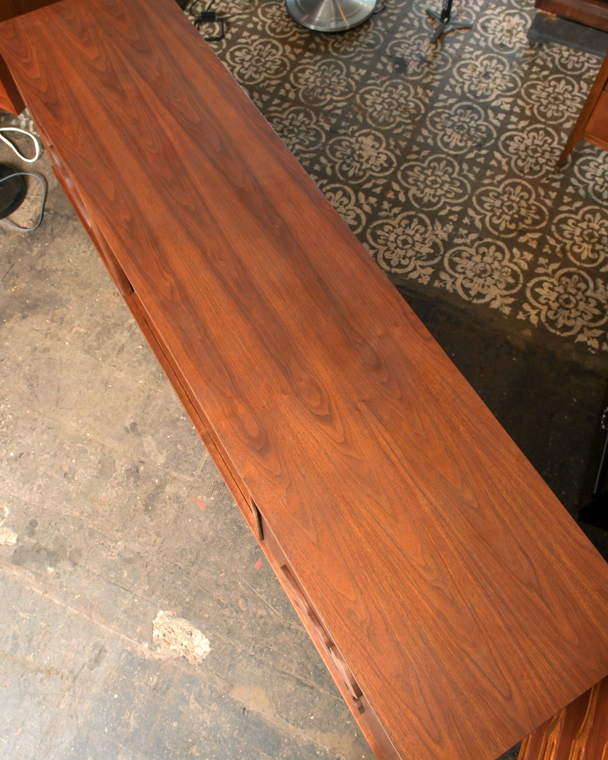 Overhead view of the walnut top showing grain and drawer lines along the case