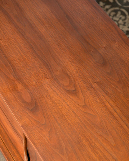 Close-up of the walnut top grain showing natural knots and figuring